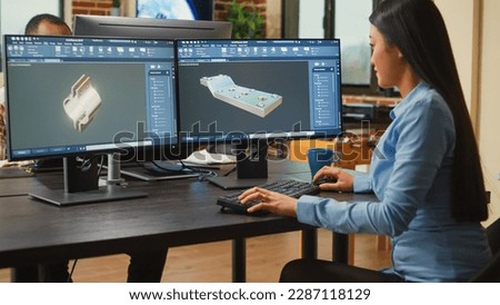 Young engineer developing industrial engine prototype on professional cad software, improving machine clamp. Asian graphic technician sketching 3D product or component, creative industry.