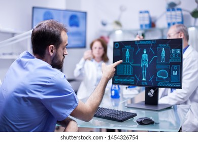 Young engineer in inovation center for body research pointing at monitor. Team of scientists in a innovation center. - Shutterstock ID 1454326754