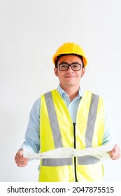 Young engineer looking at the camera holding a blueprint and carrying construction safety equipment, on white background with copy space.