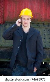 young engineer standing in front of old train