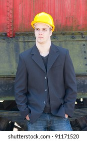 young engineer standing in front of old train