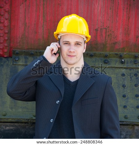 young engineer standing in front of old train