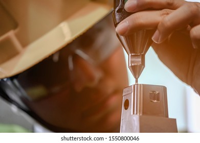 Young engineer is using a CNC machine to check the size, check the size of 3D parts after going through the forming process in the factory. To check if it meets the standards it should be.
 - Shutterstock ID 1550800046
