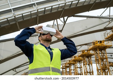 Young engineer using virtual reality glasses in his work he working on construction site