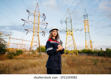 A young engineering worker inspects and controls the equipment of the power line. Energy