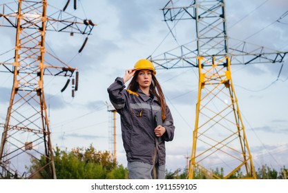 A Young Engineering Worker Inspects And Controls The Equipment Of The Power Line. Energy