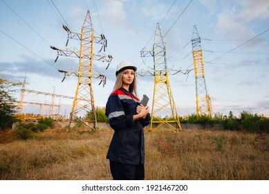 A young engineering worker inspects and controls the equipment of the power line. Energy