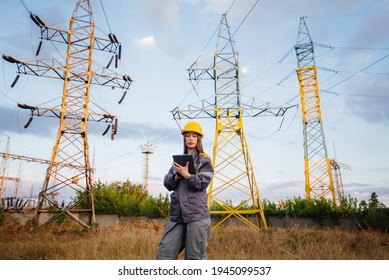 A Young Engineering Worker Inspects And Controls The Equipment Of The Power Line. Energy