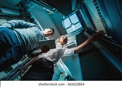 Young engineers businessmen in server room