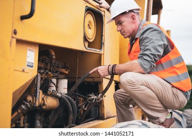 Young engineers inspected road construction vehicles in the construction site. - Powered by Shutterstock