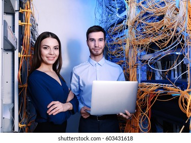 Young Engineers With Laptop In Server Room