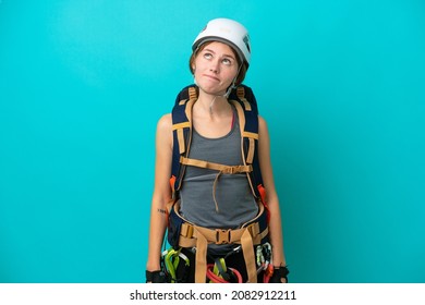 Young English Rock Climber Woman Isolated On Blue Background And Looking Up