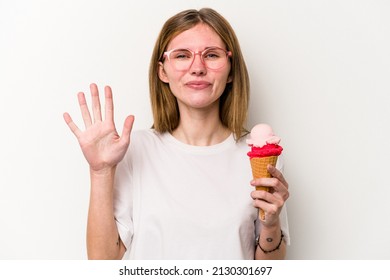Young English woman holding an ice cream isolated on white background smiling cheerful showing number five with fingers.