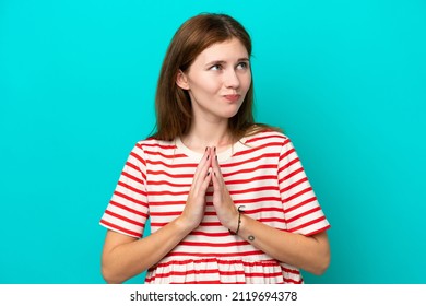 Young English woman isolated on blue background scheming something