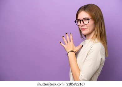 Young English woman isolated on purple background scheming something