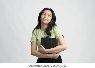 young enterpriser manager, asian working woman holding tablet and smiling, standing over green background - Powered by Shutterstock