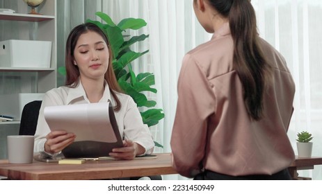 Young and enthusiastic candidate interview with professional HR manager in the office. Employer reviewing applicant's resume in preparation for employment interview. - Shutterstock ID 2231450949