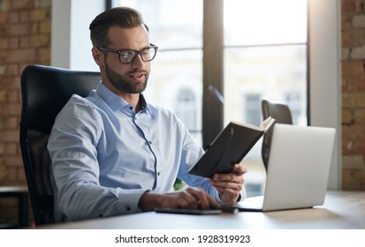 Young Entrepreneur Checking His Schedule At Work