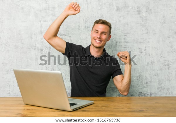 Young Entrepreneur Working His Laptop On Stock Image Download Now