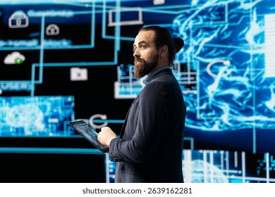 Young entrepreneur works on implementing AI brain system for deep learning, employing neural network and cybernetics for development. Driving smart technology and algorithmic thinking.