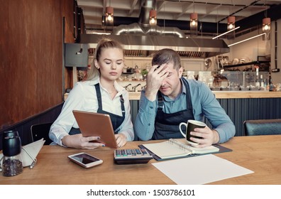 Young entrepreneurs overwhelmed by finance problems - Nervous manager checking restaurant finance - Failure in small-business concept