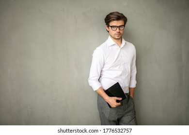 Young Entrpreneur, Smart Casual Elegant Man Standing And Posing Inside His Office, Modern Industrial Place, Confident And Serious Holding His Tablet In Hands