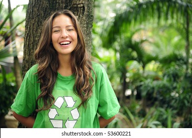 young environmental activist  in the forest wearing a green recycle t-shirt - Powered by Shutterstock