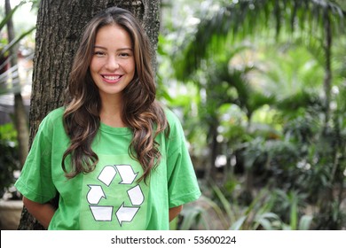 young environmental activist  in the forest wearing a green recycle t-shirt - Powered by Shutterstock