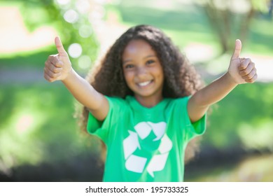 Young environmental activist smiling at the camera showing thumbs up on a sunny day - Powered by Shutterstock