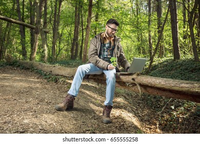 Young Environmentalist Is Working On Laptop In The Woods