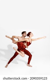 Young European Dance Couple Dancing Classical Ballet Dance. Choreography Concept. Man Holding Woman In Hands. Beautiful Slim People Isolated On White Background In Studio. Copy Space