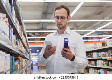 Young European Man Buying Shampoo In Shopping Mall