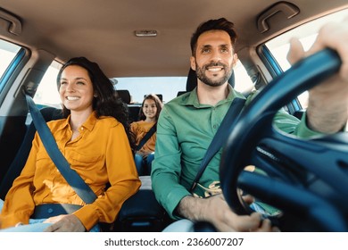 Young european parents and daughter riding new car and smiling, enjoying road trip together. Family having vacation traveling together by auto - Powered by Shutterstock