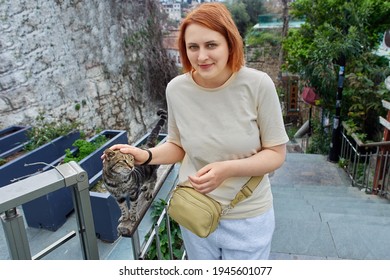 Young European Woman Caresses Turkish Stray Cat In Antalya.