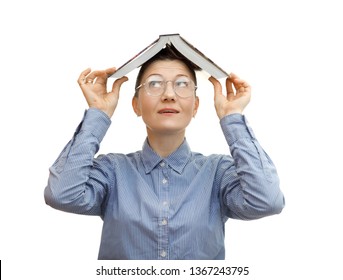 
young european woman holding a book on her head.
The girl in glasses holds a book. Portrait medium plan. Book in the form of a roof over your head. A woman is wearing a blue shirt and glasses. 