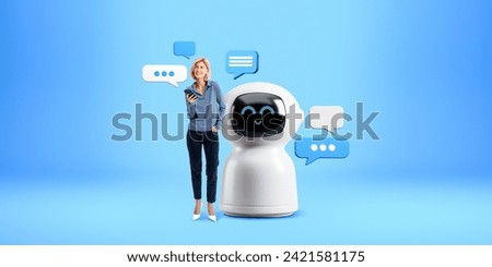 Young European woman with smartphone standing near big white AI artificial intelligence chat bot with speech bubbles over blue background. Concept of machine learning