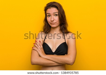 Young european woman wearing bikini unhappy looking in camera with sarcastic expression.