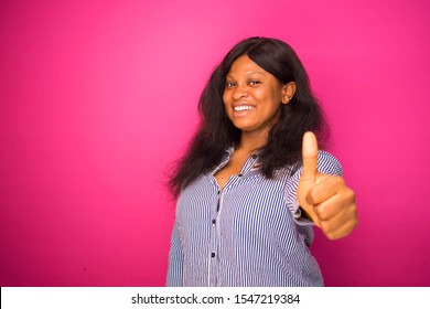 young excited african woman given a thumbs up sign.   plus size girl doing a OK sign