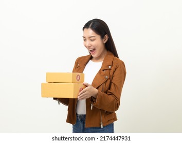 Young Excited Beautiful Asian Woman With Many Parcel Cardboard Standing On Isolated White Background. Cheerful Female Holding Lot Of Parcel Box Receive From The Delivery Service