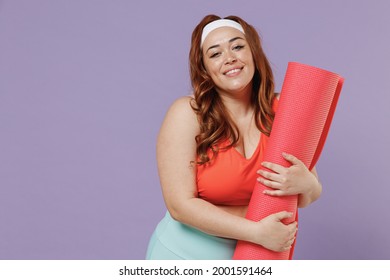 Young Excited Happy Fun Chubby Overweight Plus Size Big Fat Fit Woman 20s Wear Red Top Warm Up Training Hold Yoga Mat Caremat Isolated On Purple Background Gym Home. Workout Motivation Sport Concept.