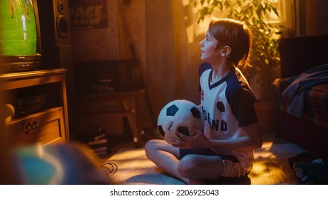 Young Excited Sports Fan Watches A Soccer Match On TV At Home. Boy Supporting His Favorite Football Team, Feeling Proud For Success Of His Favourite Player. Nostalgic And Retro Childhood Concept.