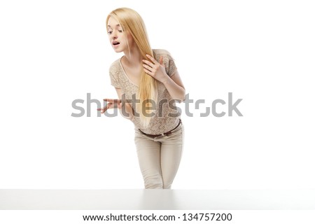 Young excited woman looking at the shop window isolated over white
