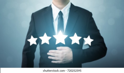 Young Executive Businessman In Suit And Five Star Symbol To Increase Rating Of Company, The Excellence Of The Business Or Service Concept