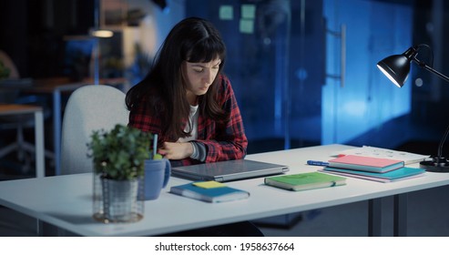 Young Exhausted Caucasian Woman Working Long Hours In Office. Angry Female Employee Closing Laptop Finishing Work And Frustrating.