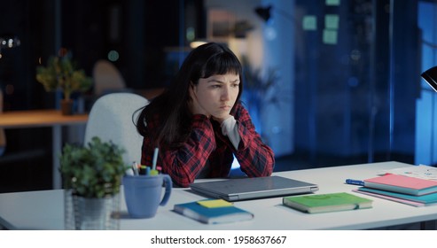 Young Exhausted Caucasian Woman Working Long Hours In Office. Angry Female Employee Closing Laptop Finishing Work And Frustrating.