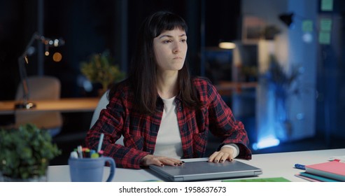 Young Exhausted Caucasian Woman Working Long Hours In Office. Angry Female Employee Closing Laptop Finishing Work And Frustrating.