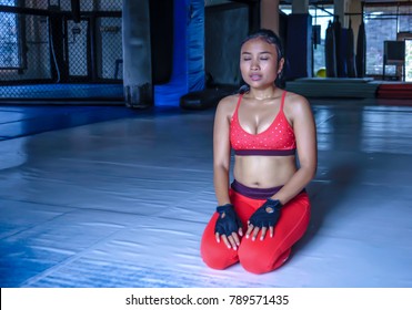 Young Exhausted Sweaty Asian Woman In Sport Clothes Breathing And Stretching After Hard Training Fitness Workout Relaxing Muscles Cooling Off And Doing Meditation Exercise After Workout