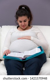 Young Expectant Mom Reading Her Bible In The Morning