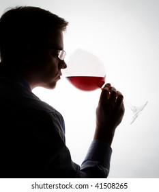 young expert sampling red wine
