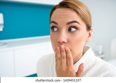 Young fair haired woman having her eyes wide open and looking away with expression of surprise on her face - Shutterstock ID 1439451197